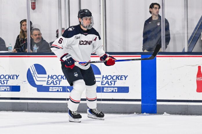This UConn hockey defender towers over the ice, above the competition