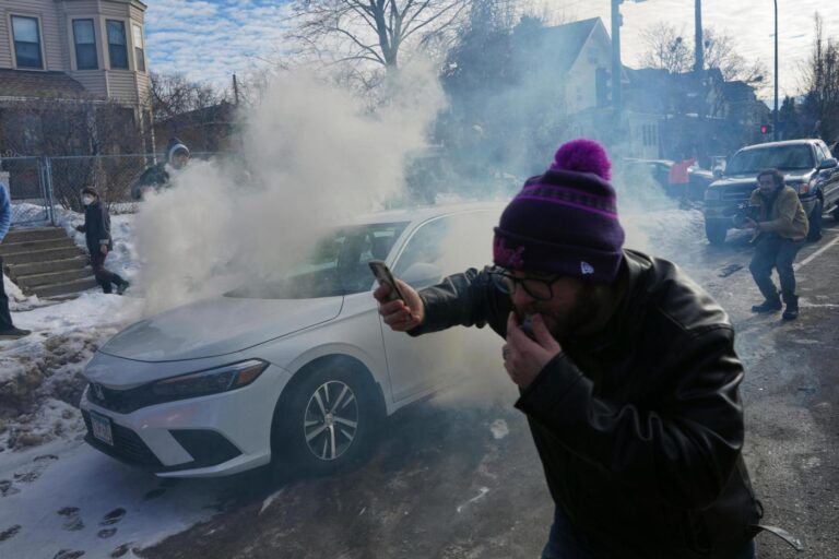 Crowd yells ‘cowards!’ after federal agents crash into a car and fire tear gas in Minneapolis